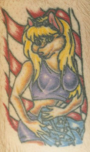 Blonde girl with wolf head tattoo