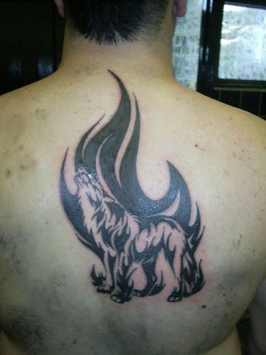 Back wolf tattoo with black fire