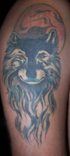 Beautiful blue wolf tattoo with the moon