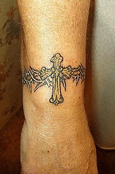 Golden cross wrist tattoo