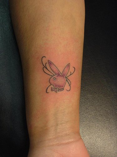 Playboy tattoo on inner side of hand