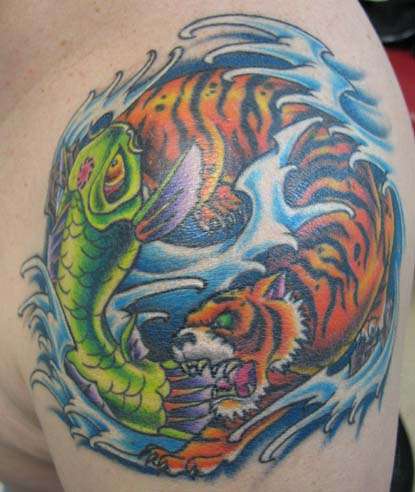 Colorful yin yang tattoo with a fish and a tiger
