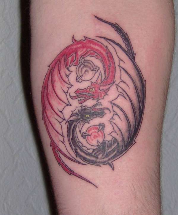 Yin yang tattoo with red and black dragons
