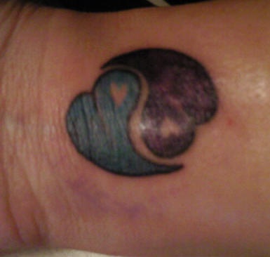 Yin and yang tattoo with hearts