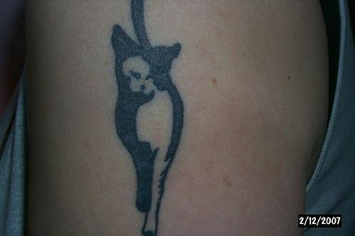 Minimalistic black cat tattoo