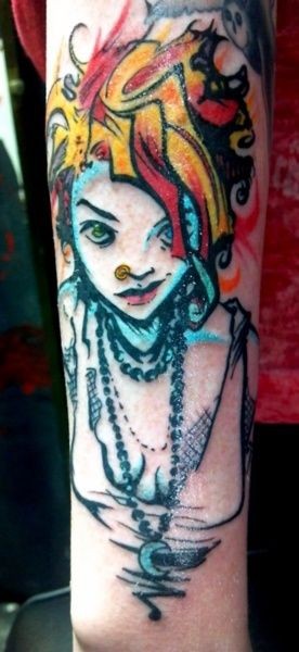 Teenage girl punk with colored hairdo and piercing modern style tattoo on arm with tiny black cat