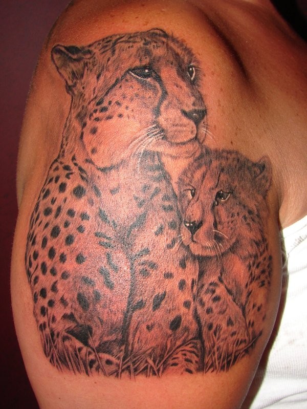 Tender gray-ink cheetah mother and baby tattoo on upper arm