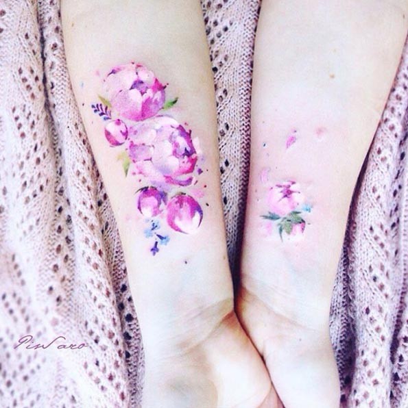 Tender pale pink peony flowers delicate watercolor like tattoo on girl&quots wrist