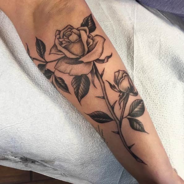 Tender rose flower with thorns detailed leg length tattoo