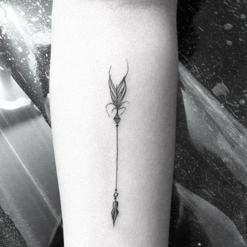 Tender tribal arrow tattoo for ladies legs