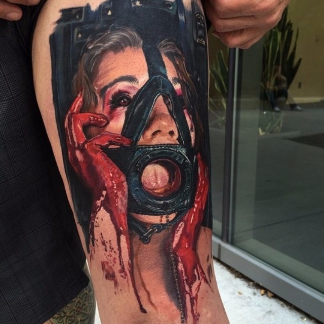 Tatuaje en el brazo,
mujer asustada en máscara con manos en sangre