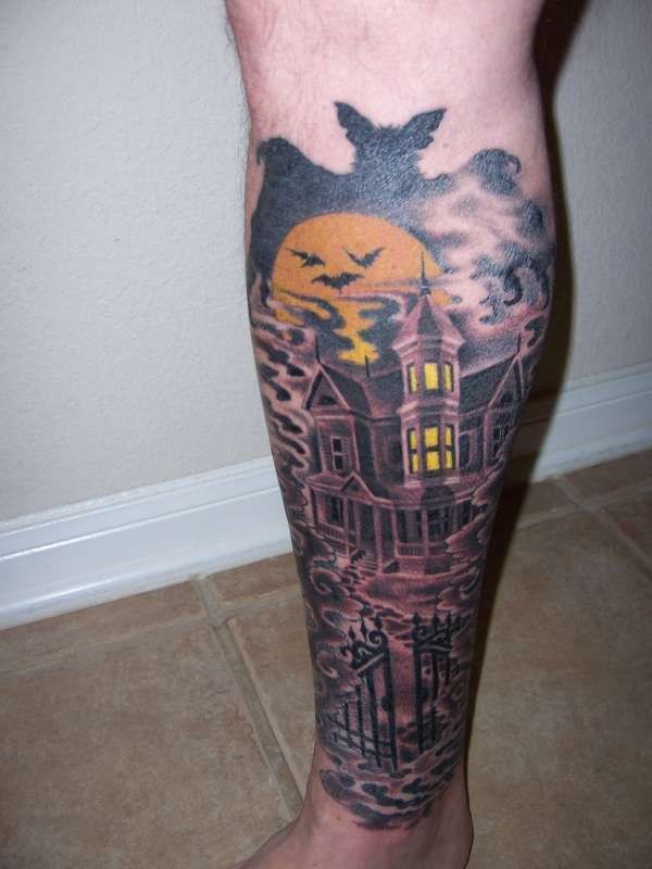 Terrifying big mystical old house tattoo on leg with bats and moon