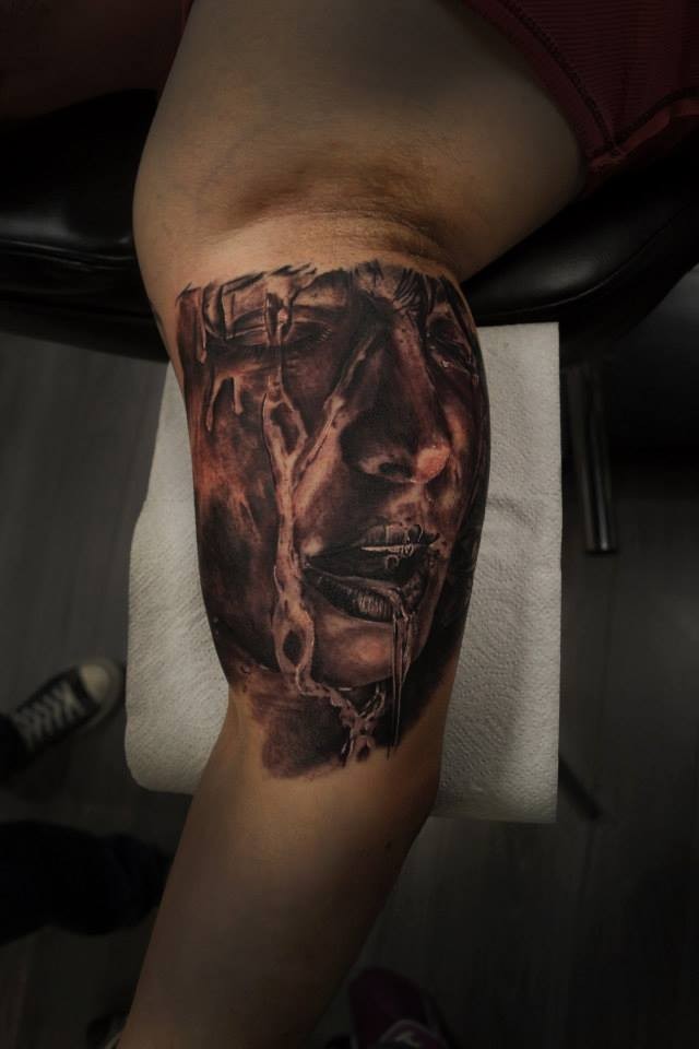 Terrifying black and gray style biceps tattoo of woman face