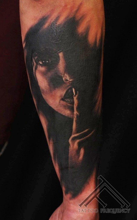 Terrifying black ink forearm tattoo of dark woman face