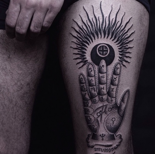 Terrifying looking black ink thigh tattoo of mysterious hand with symbols and sun