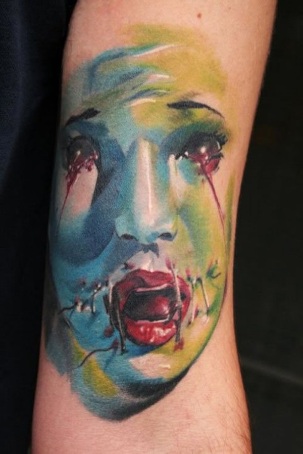Terrifying looking colored arm tattoo of bloody monster woman