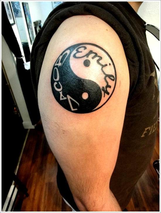 Tatuaje en el brazo, yin yang y inscripción en él