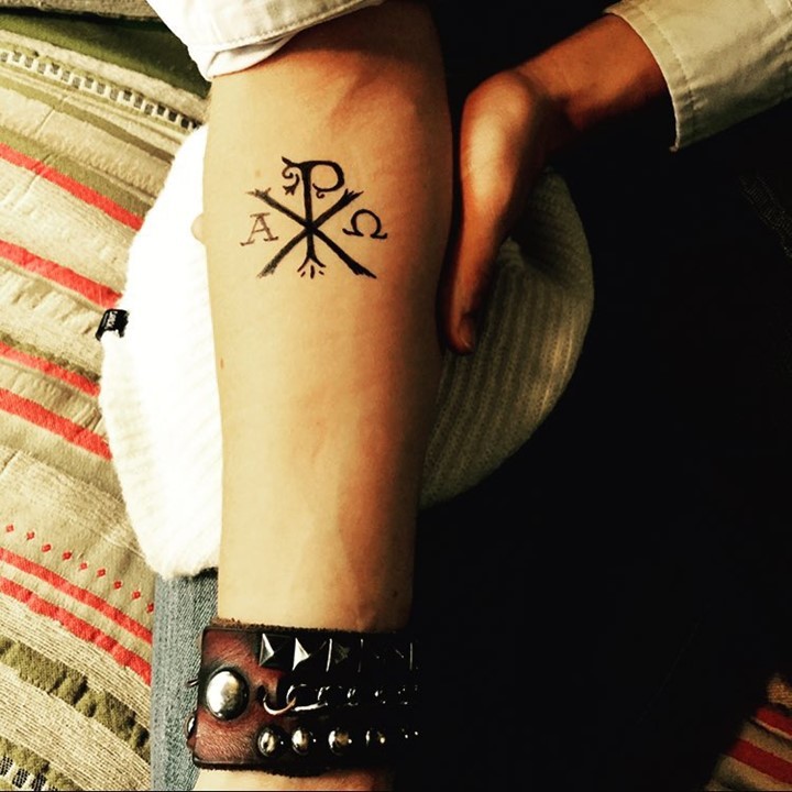 Thin and neat dark black Christ special monogram Chi Rho forearm tattoo