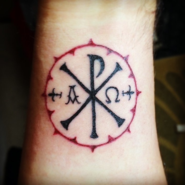 Thin dark black religious special Chi Rho symbol Christ monogram in red circle wrist tattoo