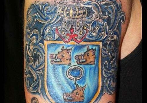 Three boar family crest tattoo on arm