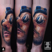 3D colored forearm tattoo of man portrait with sunglasses