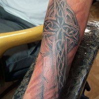 3D like ancient Celtic cross black ink tattoo on arm