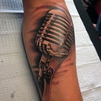 3D like big black ink vintage microphone tattoo on arm
