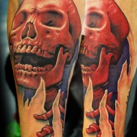Tatuaje  de esqueleto rojo sonriente en el antebrazo