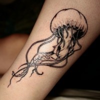 3D like little black ink jelly-fish tattoo on ankle