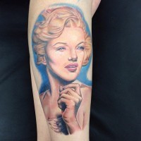 3D like multicolored Merlin Monroe portrait tattoo on arm