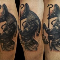 3D like natural looking black ink Anubis God statue tattoo on forearm