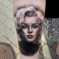 3D like natural looking Merlin Monroe portrait tattoo on arm