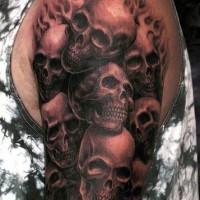 3D like realistic skulls in flames tattoo on shoulder