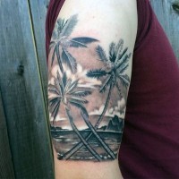 3D like very realistic looking black and white palm trees with ocean shoulder tattoo