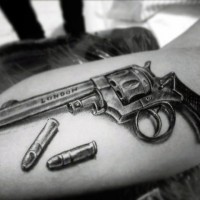 3D like very realistic old revolver with bullets tattoo on arm