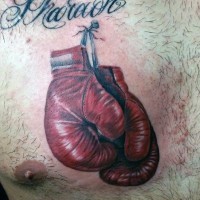 3D realistic colored boxing gloves nailed to chest tattoo with lettering