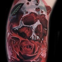 3D realistic painted big colored bloody skull with rose tattoo on arm