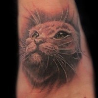 3D realistic pale colored cat's portrait tattoo on foot
