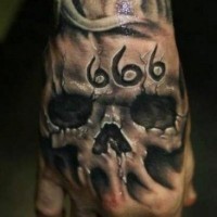 3D realistic very detailed black and white skull with devils number tattoo on hand