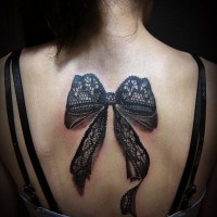 3D realistic very detailed black ink big bow tattoo on upper back