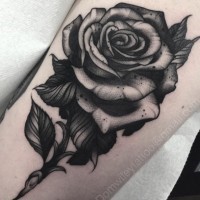 3D style big black ink rose tattoo on forearm
