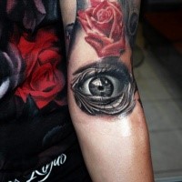 3D style black and white arm tattoo of human eye and red rose
