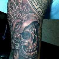 3D style black and white forearm tattoo of tribal skull with helmet