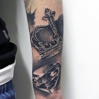 3D style black and white forearm tattoo of diamond with crown