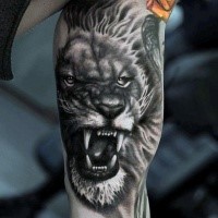 3D style black ink biceps tattoo of roaring lion