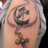 Tatuaje en el brazo,
cruz simple con emblema