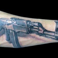 3D style colored arm tattoo of AK 47 rifle