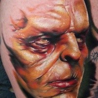 3D style colored creepy looking monster man face tattoo on leg