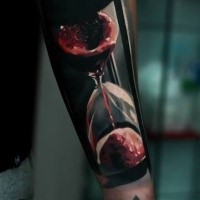 3D style colored forearm tattoo of bloody clock