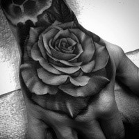 3D style colored hand tattoo of dark rose